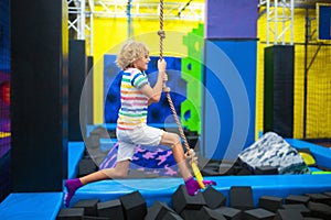 Child jumping in trampoline park. Bounce fun