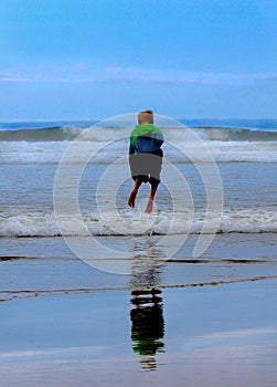 Child Jumping Waves at Beach