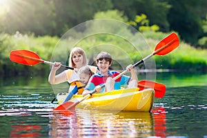 Child on kayak. Kids on canoe. Summer camping.