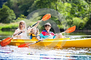 Child on kayak. Kids on canoe. Summer camping