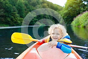 Child on kayak. Kids on canoe. Summer camping.