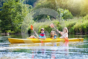 Child on kayak. Kids on canoe. Summer camping