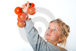 Child keeping up tomato