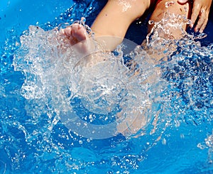 Child kicking in pool