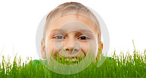 Child kid boy face closeup happy smile green grass isolated white