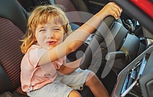 Child kid driver. Child boy driving car as driver. Baby kid sitting in seat.