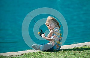 Child kid fisher. Boy with spinner at river. Little boy fishing. Boy at jetty with rod. Fishing concept.