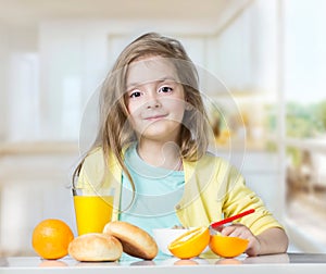 Child kid girl eating at table fruits indoors.