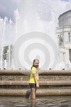 Child kid girl taking rest near fountain