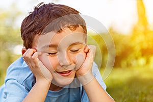 Child kid little boy day dreaming daydreaming thinking outdoor c photo