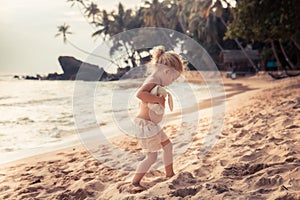 Child kid playing on beach during summer holidays concept happy childhood travel lifestyle