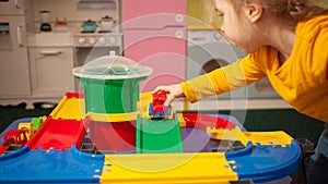 child in kindergarten, playroom, playing with toys, learning. Plays with