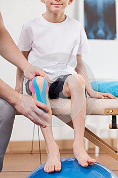 Child with kinesio taping application