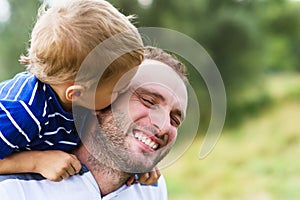 Child kissing father