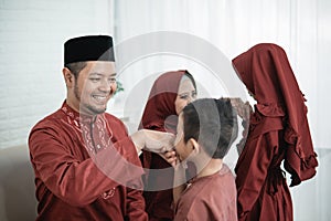 Child kissing his father`s hand to apologize