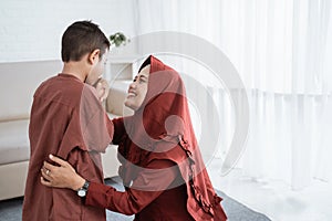 Child kissing his mother`s hand to apologize