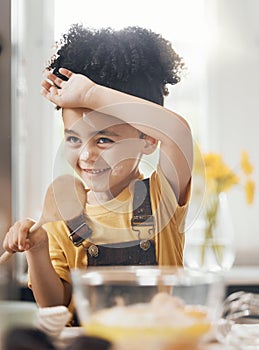 Child in kitchen, baking with wooden spoon and cake flour on face, little baker making breakfast or cookies. Learning