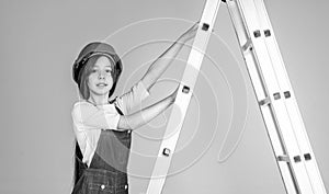 child on ladder wear hard hat. kid builder on construction site. worker engineer. architect in workshop. renovation and