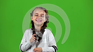 Child laughs gaily. Green screen. Slow motion