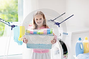 Child in laundry room with washing machine