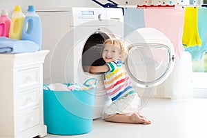 Child in laundry room with washing machine