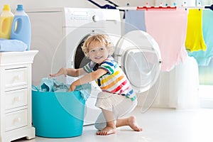 Child in laundry room with washing machine