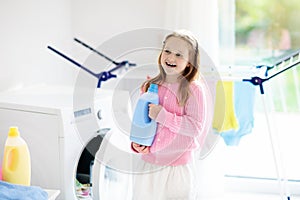 Child in laundry room with washing machine