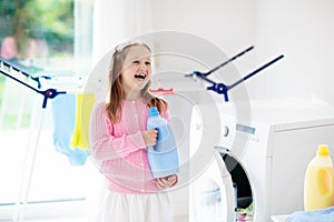 Child in laundry room with washing machine