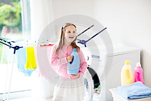 Child in laundry room with washing machine