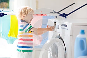 Child in laundry room with washing machine