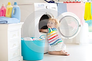 Child in laundry room with washing machine