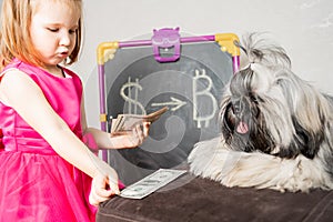 the child lays out his accumulated money in front of his dog. We convert dollars into bitcoins