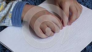 Child learning Braille at school