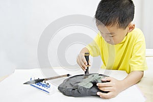 A child learning Chinese Calligraphy