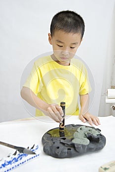 A child learning Chinese Calligraphy