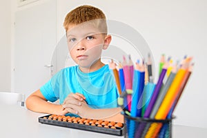 Child with learning difficulty in occupational therapy. A boy doing playful exercises during math tutoring session.