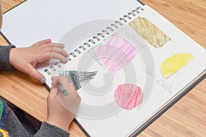 Child learning at home. Pre school age child learning about shapes and hand writing