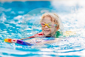 Child learning to swim. Kids in swimming pool