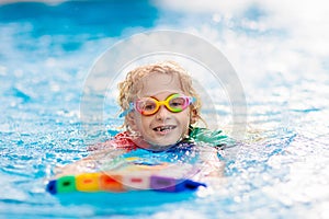 Child learning to swim. Kids in swimming pool