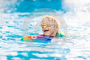 Child learning to swim. Kids in swimming pool