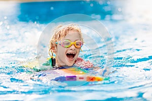 Child learning to swim. Kids in swimming pool