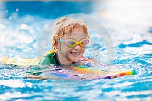 Child learning to swim. Kids in swimming pool