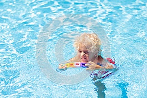 Child learning to swim. Kids in swimming pool