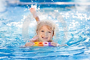 Child learning to swim. Kids in swimming pool