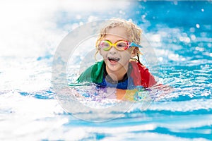 Child learning to swim. Kids in swimming pool