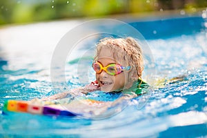 Child learning to swim. Kids in swimming pool