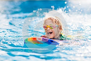 Child learning to swim. Kids in swimming pool