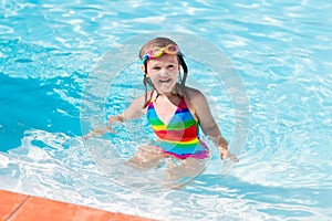 Child learning to swim in pool