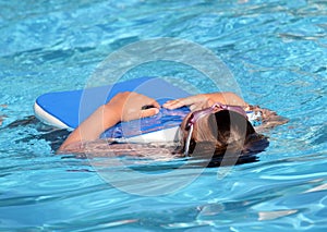 Child learning to swim, swimming lesson