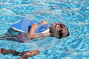 Child learning to swim, swimming lesson